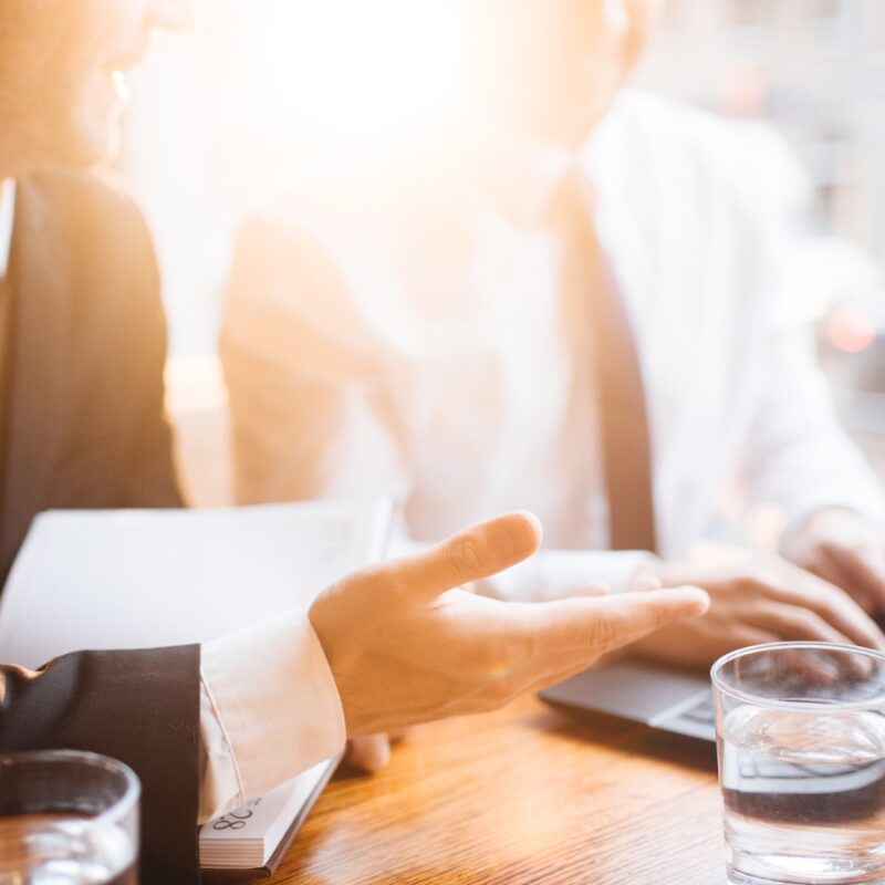 Two men sit in a bright office overviewing marketing leads.