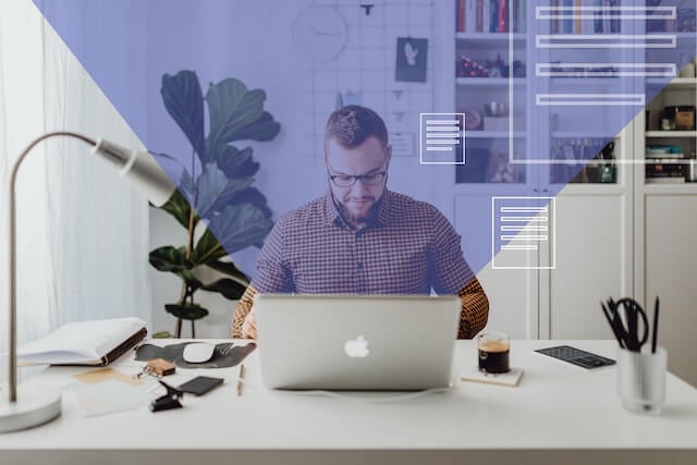 A man sitting at his laptop working on an email outreach strategy